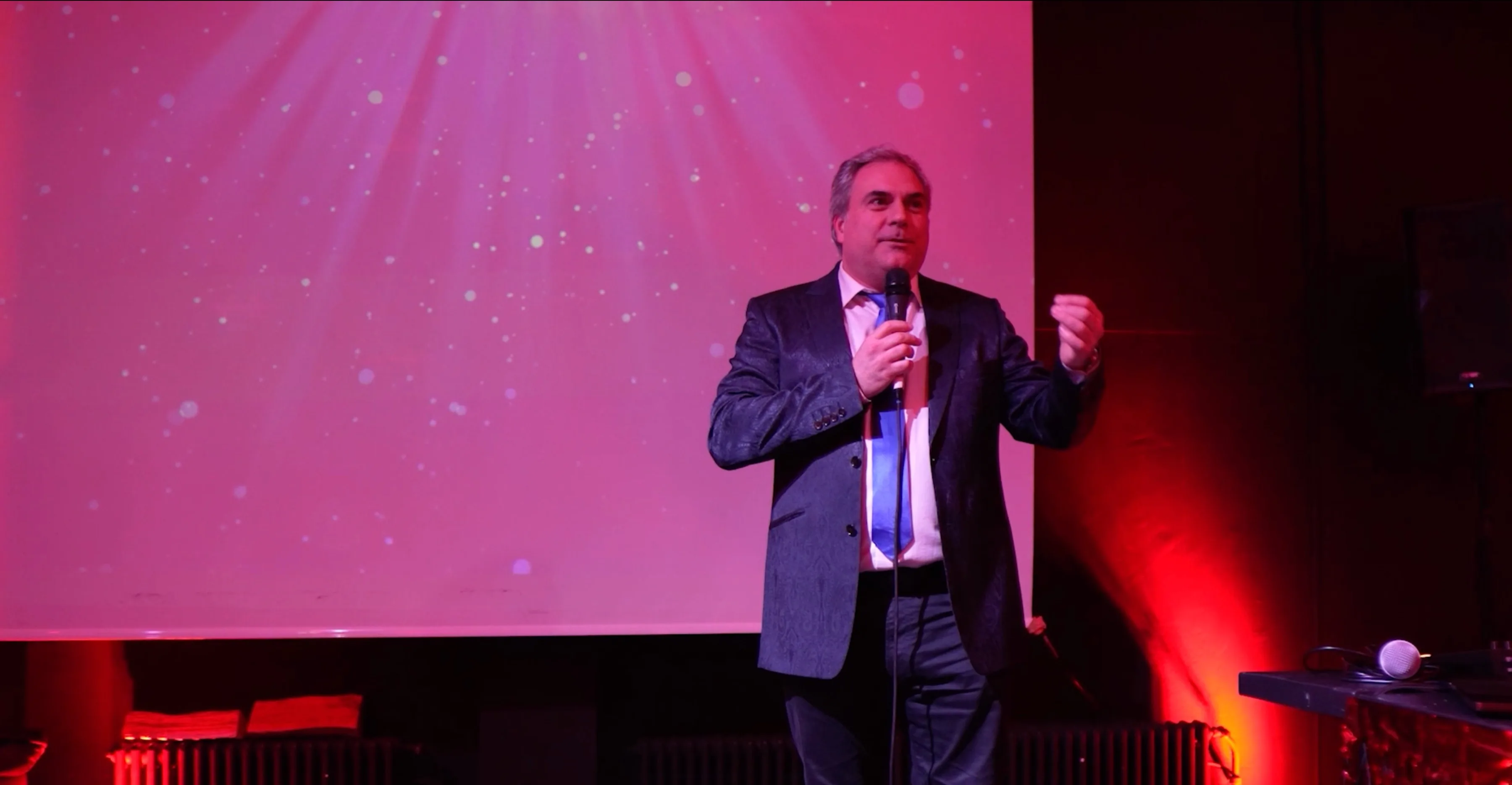 Damien Gauthier speaking on stage at TEDxLausanne