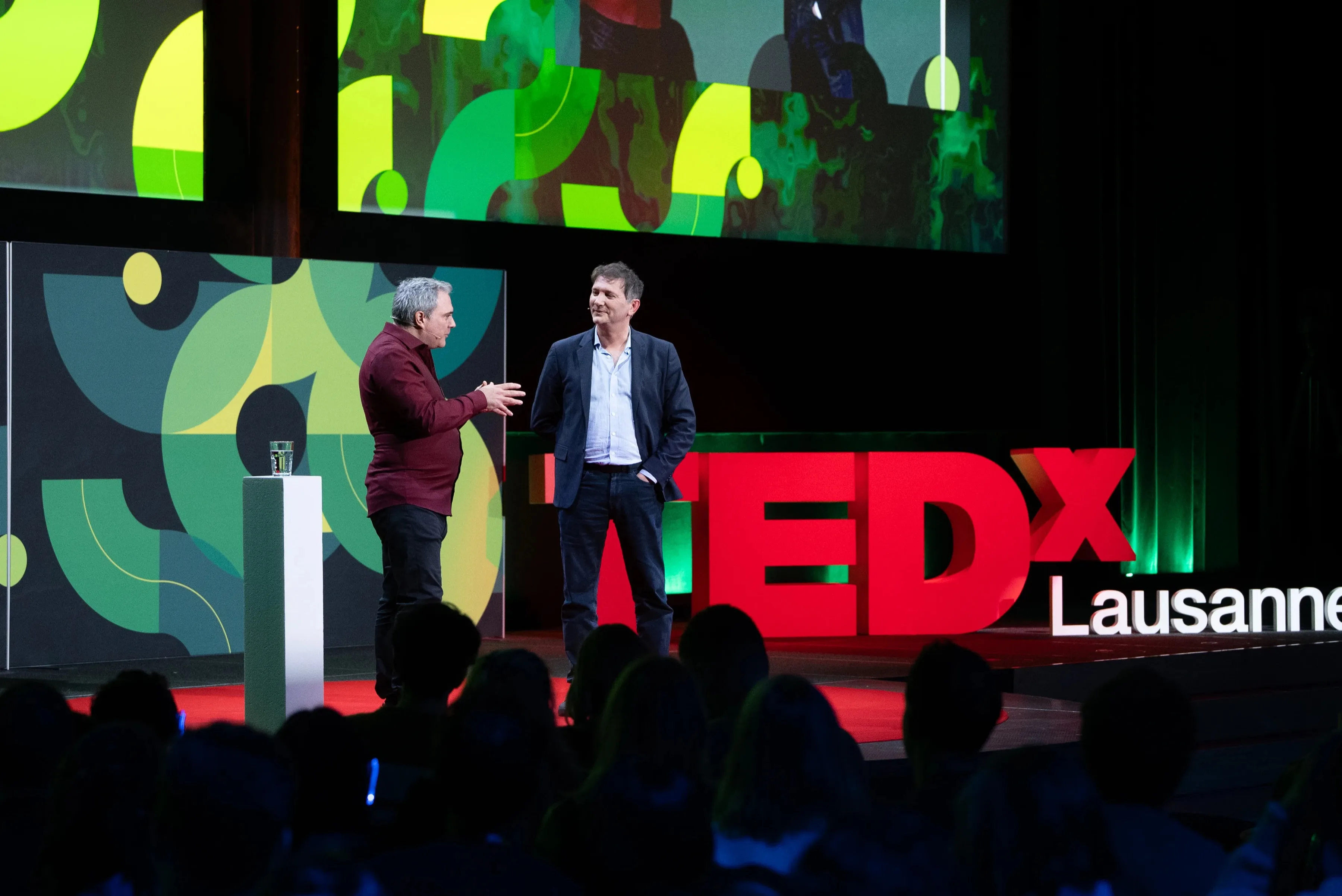 TEDx Lausanne 2025 — speaker on stage, full auditorium